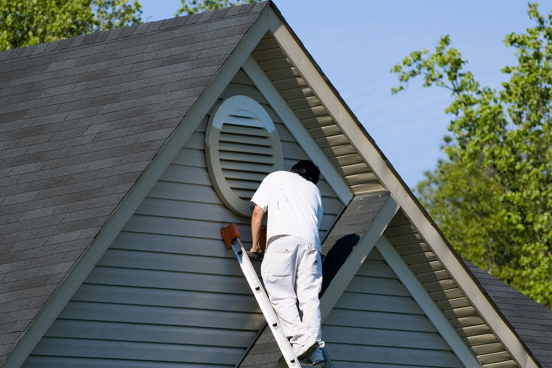 Painter working at roofline